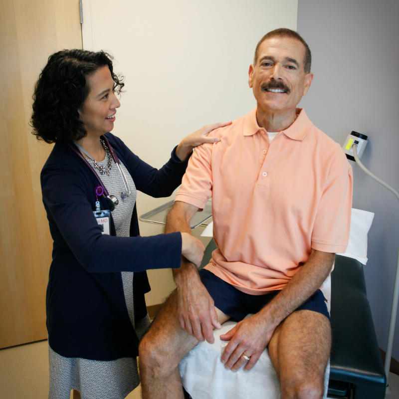 man and doctor in exam room