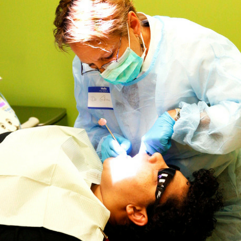 dentist examines a boys teeth